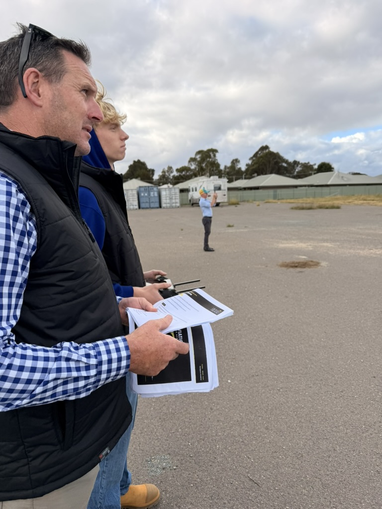 Remote pilot and spotter checking airspace during a training flight