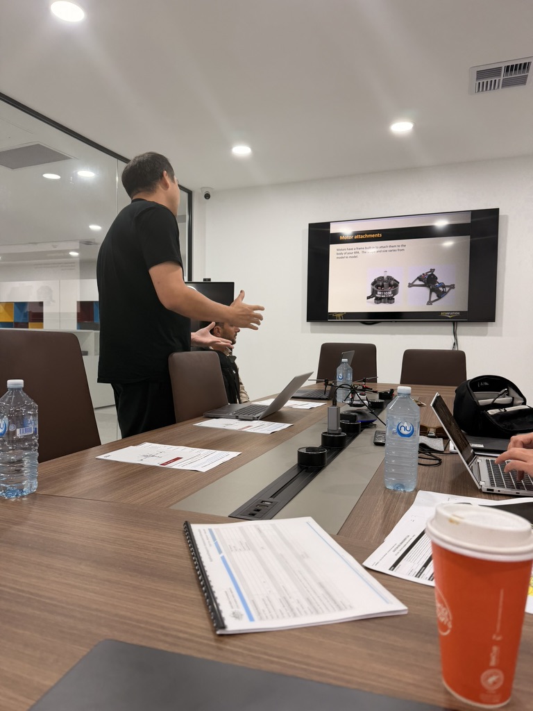 Instructor presenting a drone systems lesson on motor attachments in the classroom