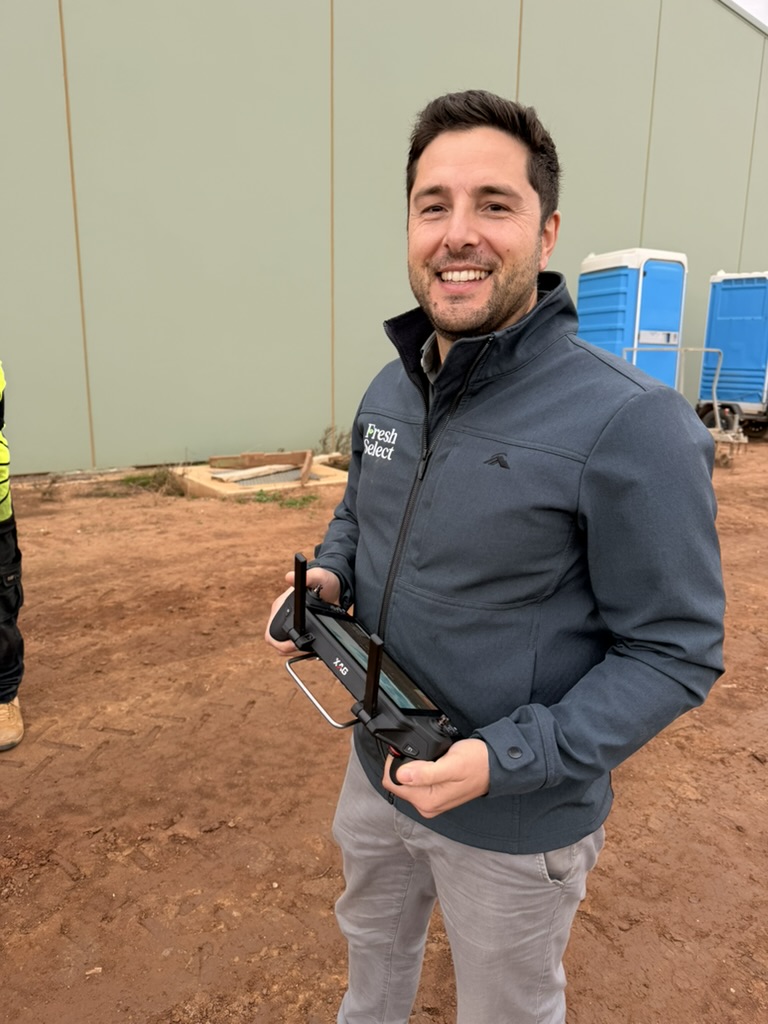 ACE Aviation graduate operating an XAG drone controller in the field