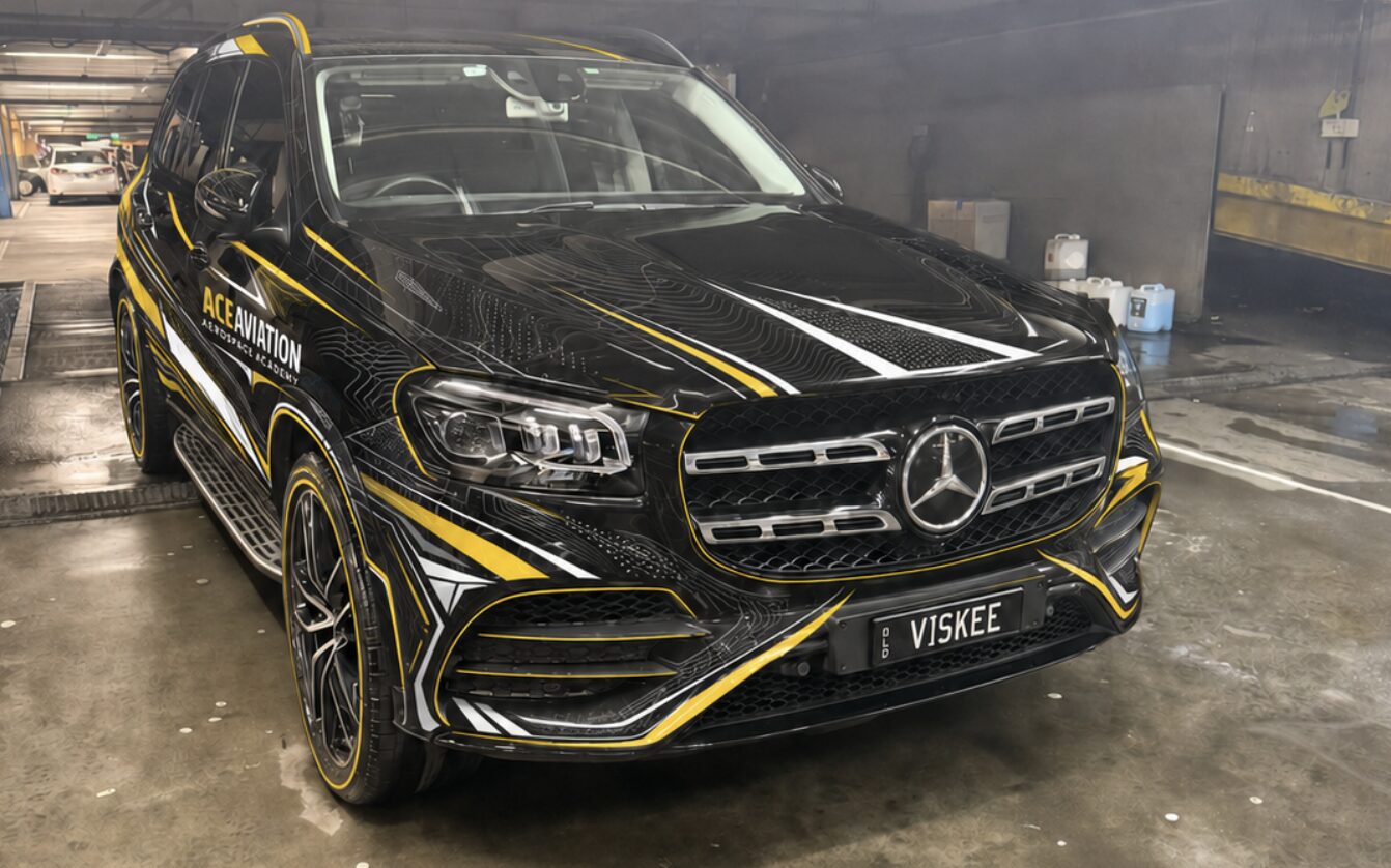 ACE Aviation branded training vehicle in black and gold wrap
