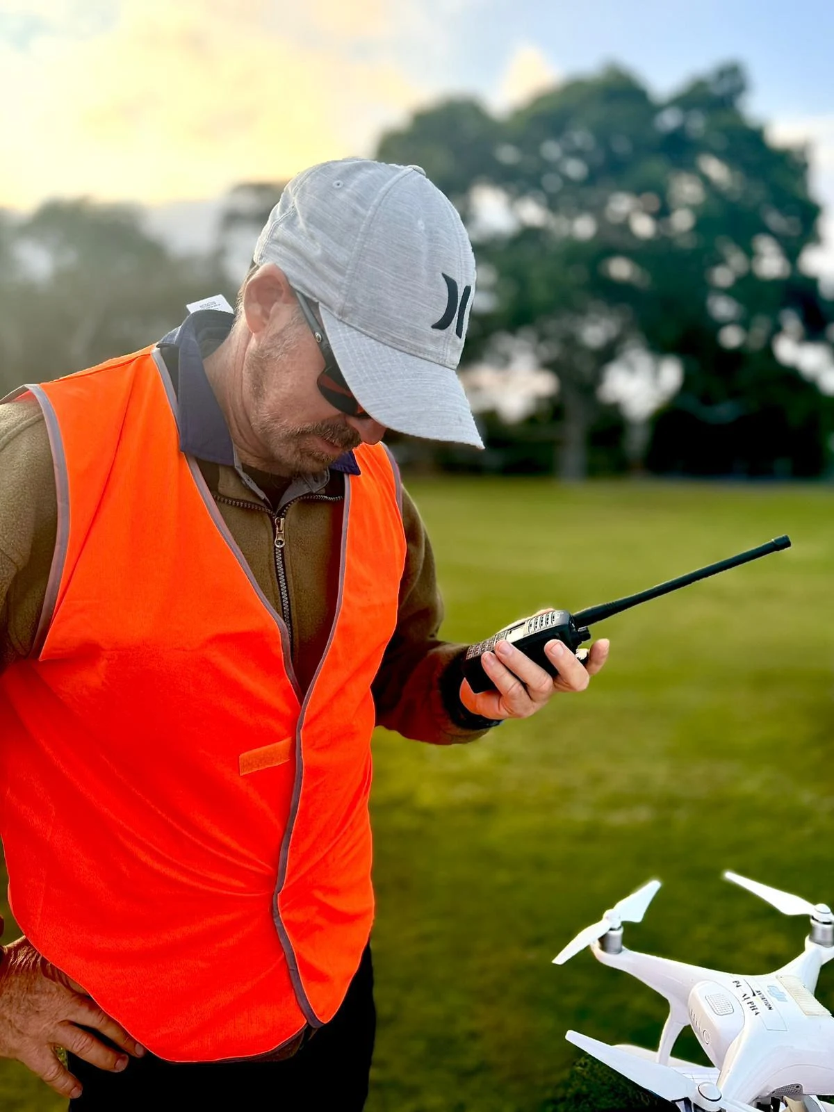 Drone operator using an aviation radio in the field — AROC (Aeronautical Radio Operator Certificate) training with aroc.au