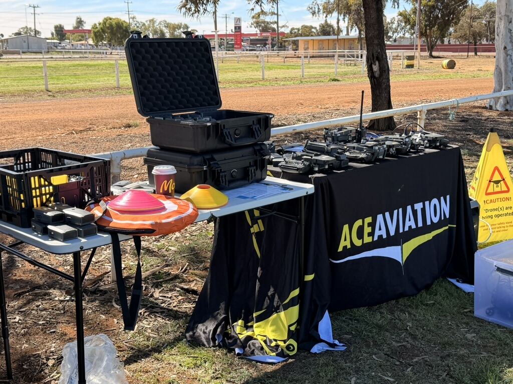 ACE Aviation's mobile field setup with drone cases and equipment at Leonora District High School
