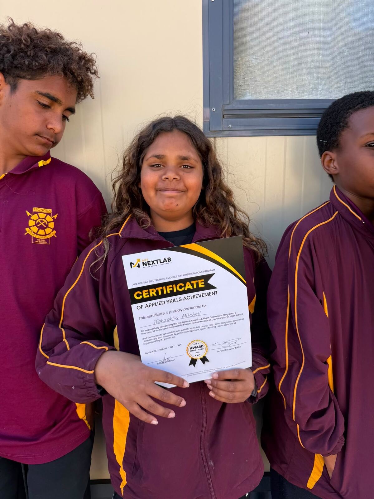Three Leonora students proudly holding an ACE NextLab certificate