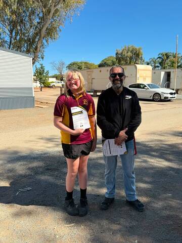 A student receiving her certificate from an ACE instructor