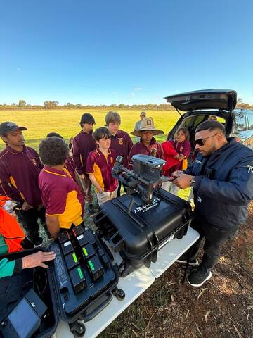 ACE instructor demonstrating drone equipment to Leonora students