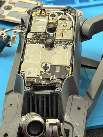A drone opened up for inspection on the repair mat