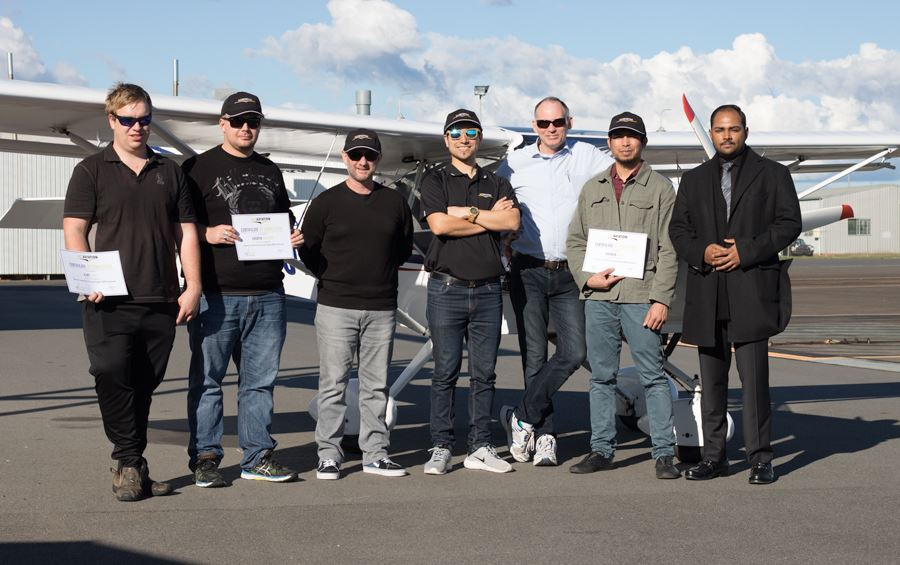 ACE Aviation graduates holding RePL certificates in front of a Cessna aircraft