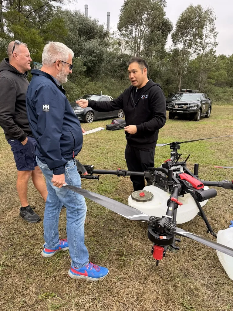 A hands-on briefing beside an XAG agricultural drone